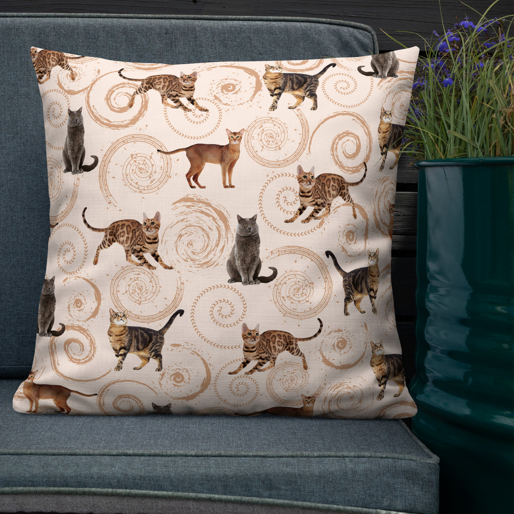 Cream accent pillow featuring illustrated cats in gray, brown, and tabby patterns surrounded by spiral swirls, luxury cat lover home décor by Pets N’ Faith.