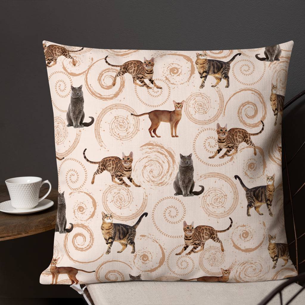 Cream accent pillow featuring illustrated cats in gray, brown, and tabby patterns surrounded by spiral swirls, luxury cat lover home décor by Pets N’ Faith.