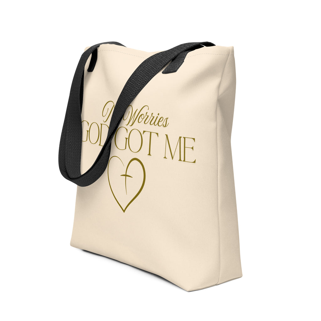 Soft peach tote bag with the words, " No Worries, God Got Me", with a gold heart and cross design.