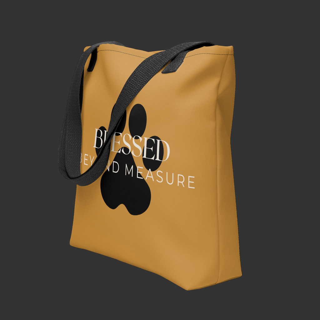 Caramel Tote Bag with the words, " Blessed Beyond Measure" with a large paw print adorning the tote bag. 