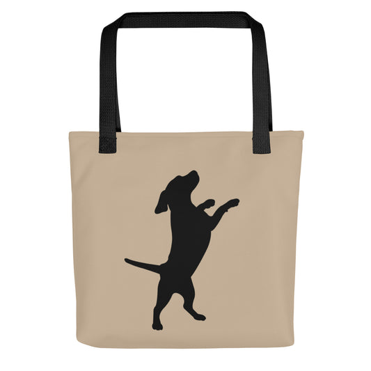Beige tote bag with black dog silhouette and black handles on a white background