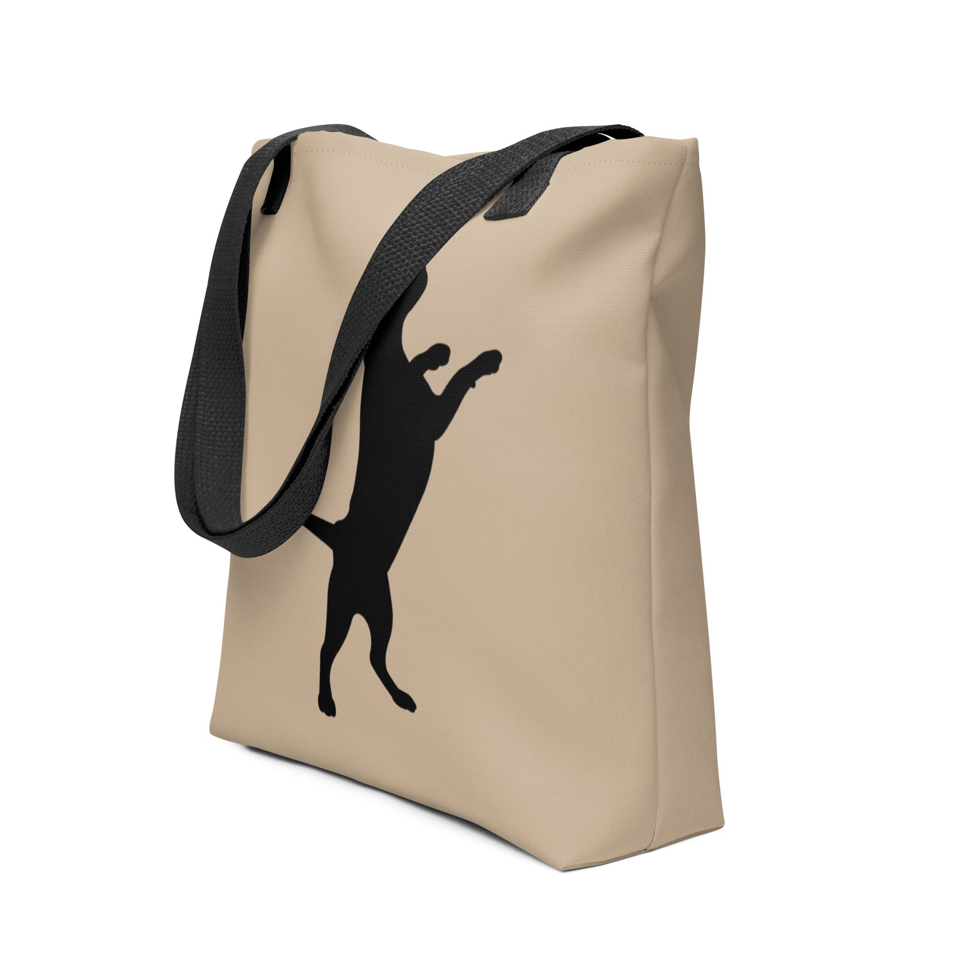 Beige tote bag with black silhouette of a dancing cat on a white background