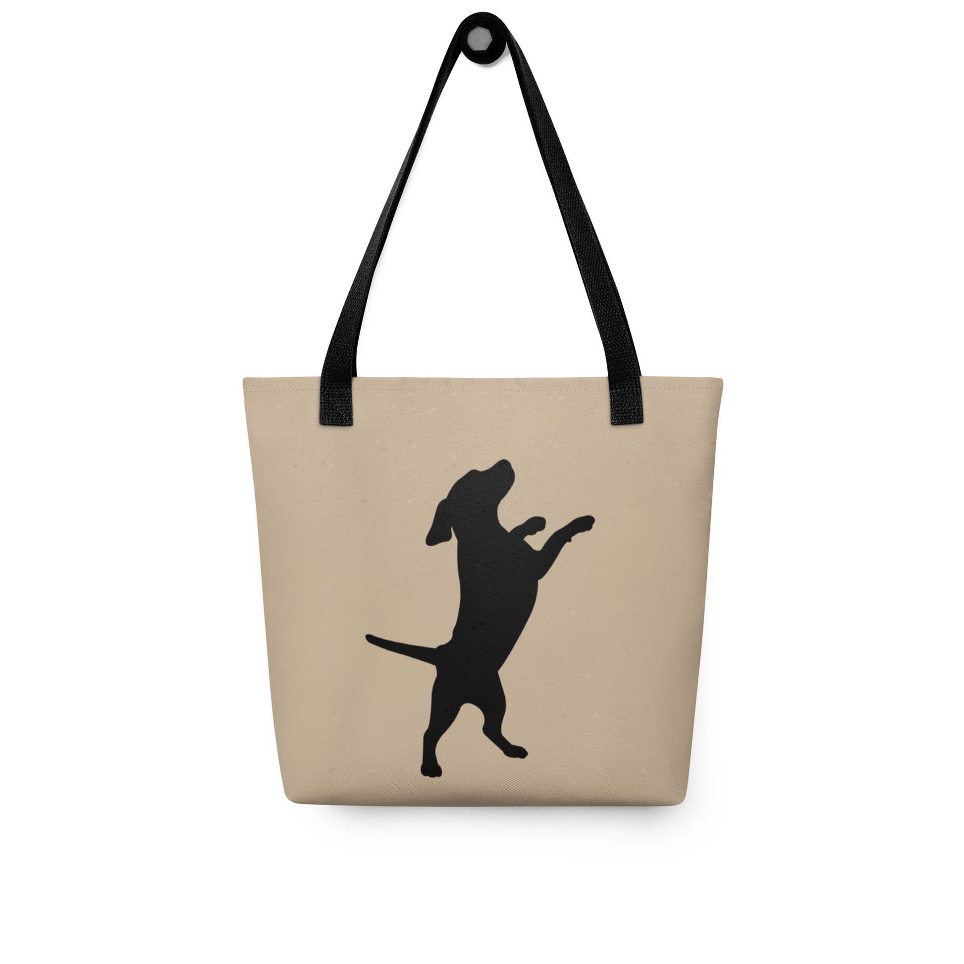 Beige tote bag with black dog silhouette and handle on a white background