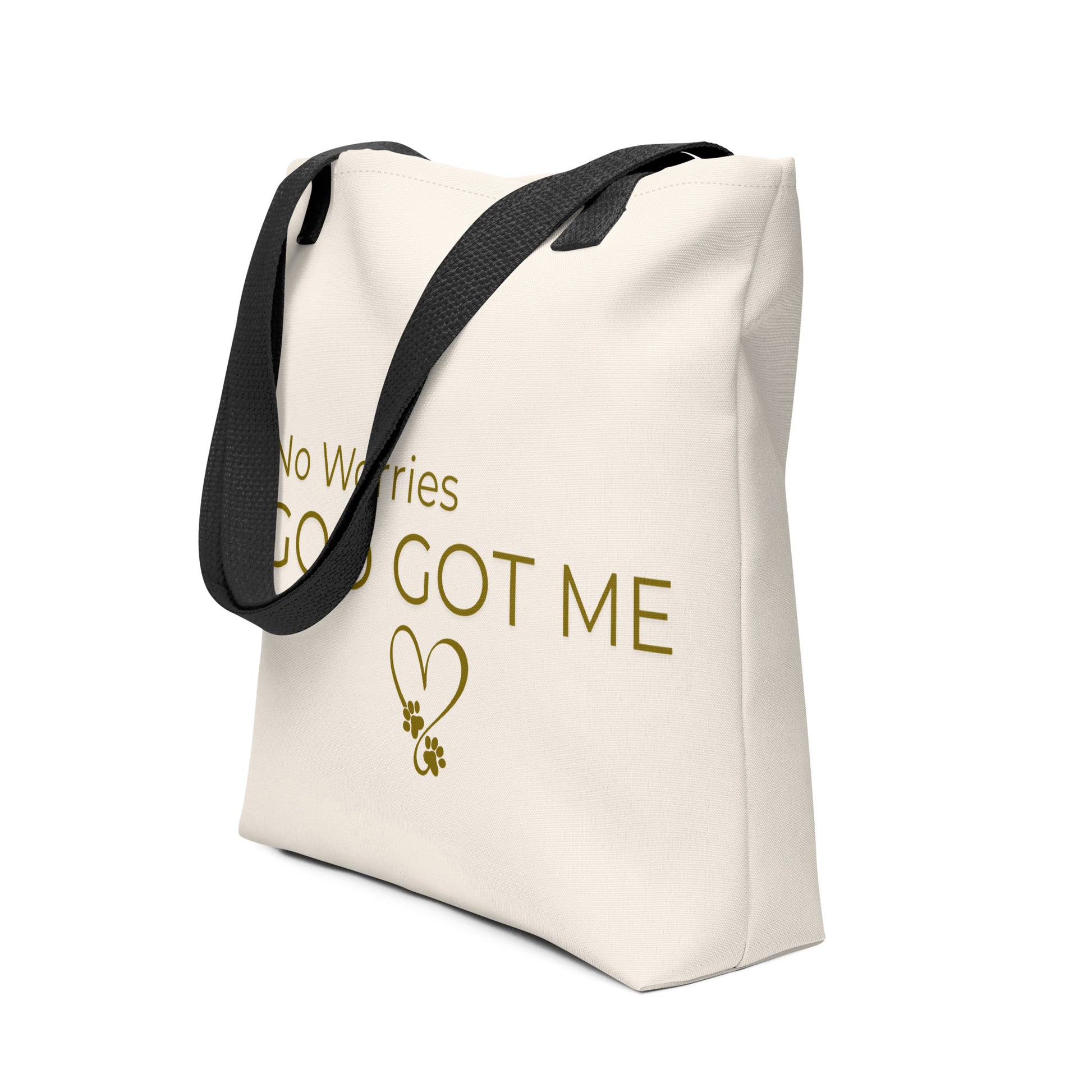 Beige tote bag with 'No Worries God Got Me' text and black handle on a white background