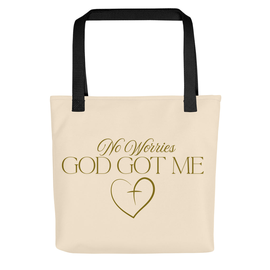 Soft peach tote bag with the words, " No Worries, God Got Me", with a gold heart and cross design.