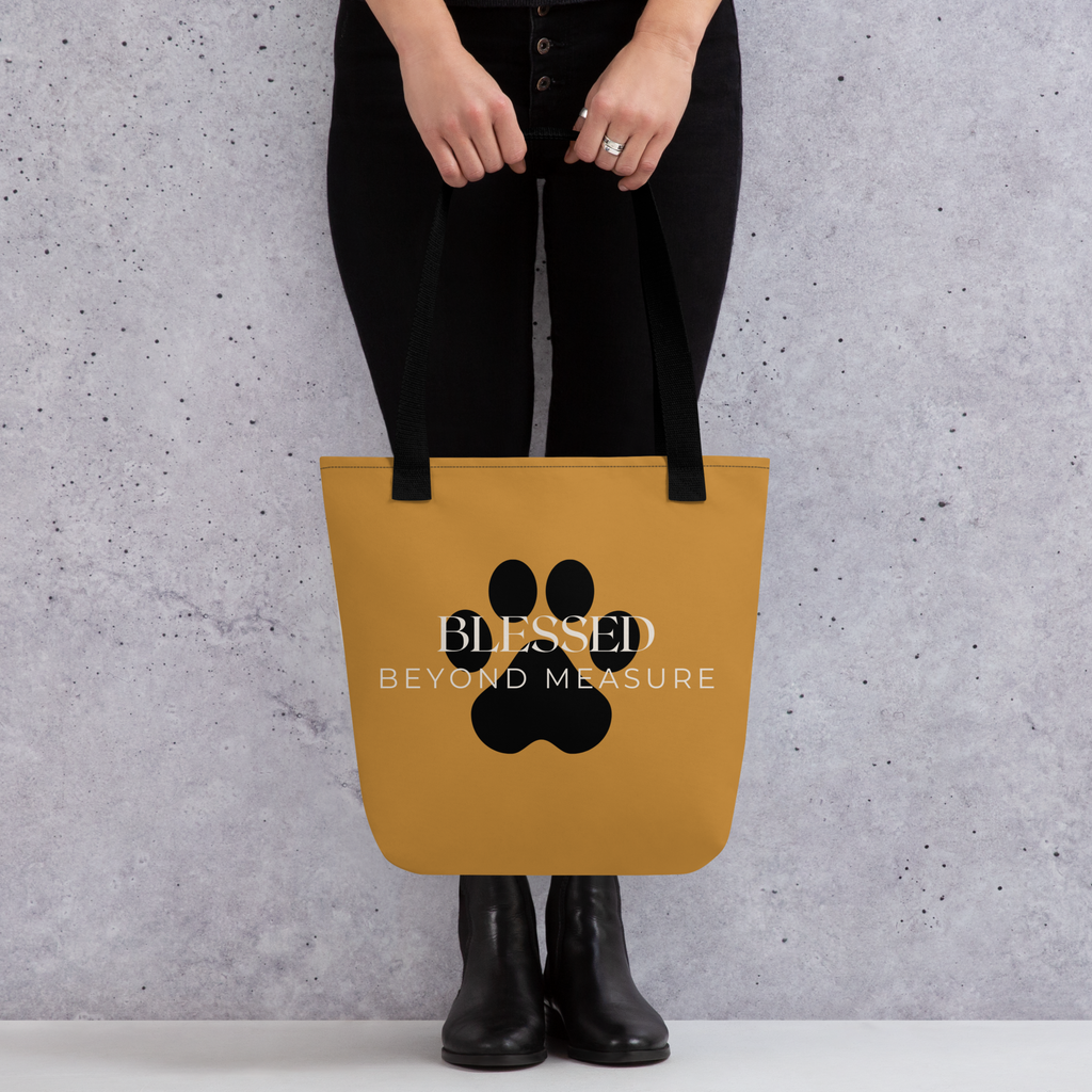Caramel Tote Bag with the words, " Blessed Beyond Measure" with a large paw print adorning the tote bag. 