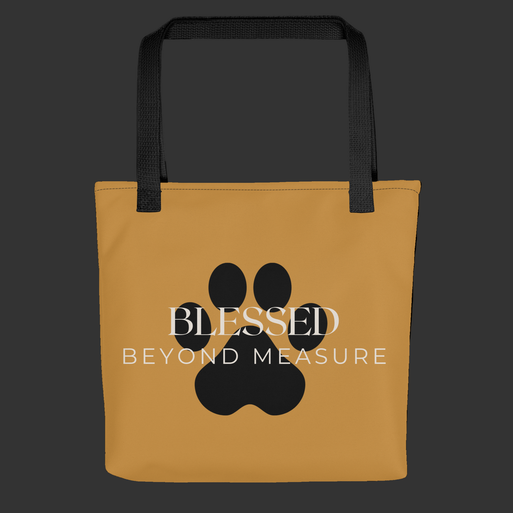 Caramel Tote Bag with the words, " Blessed Beyond Measure" with a large paw print adorning the tote bag. 