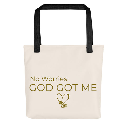 Beige tote bag with 'No Worries God Got Me' text and black handles on a white background
