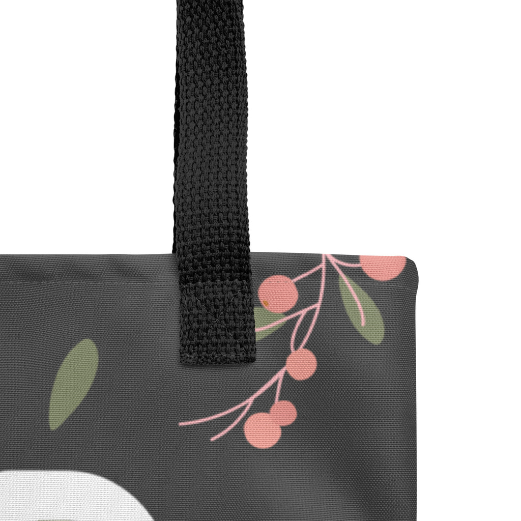 Close up view of canvas tote bag with floral design with the phrase, " God IS Love" on the front.