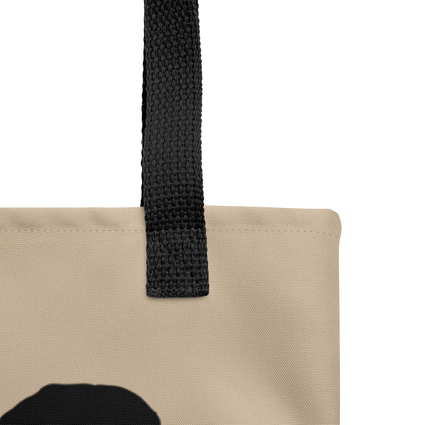 Beige tote bag with a black strap on a white background
