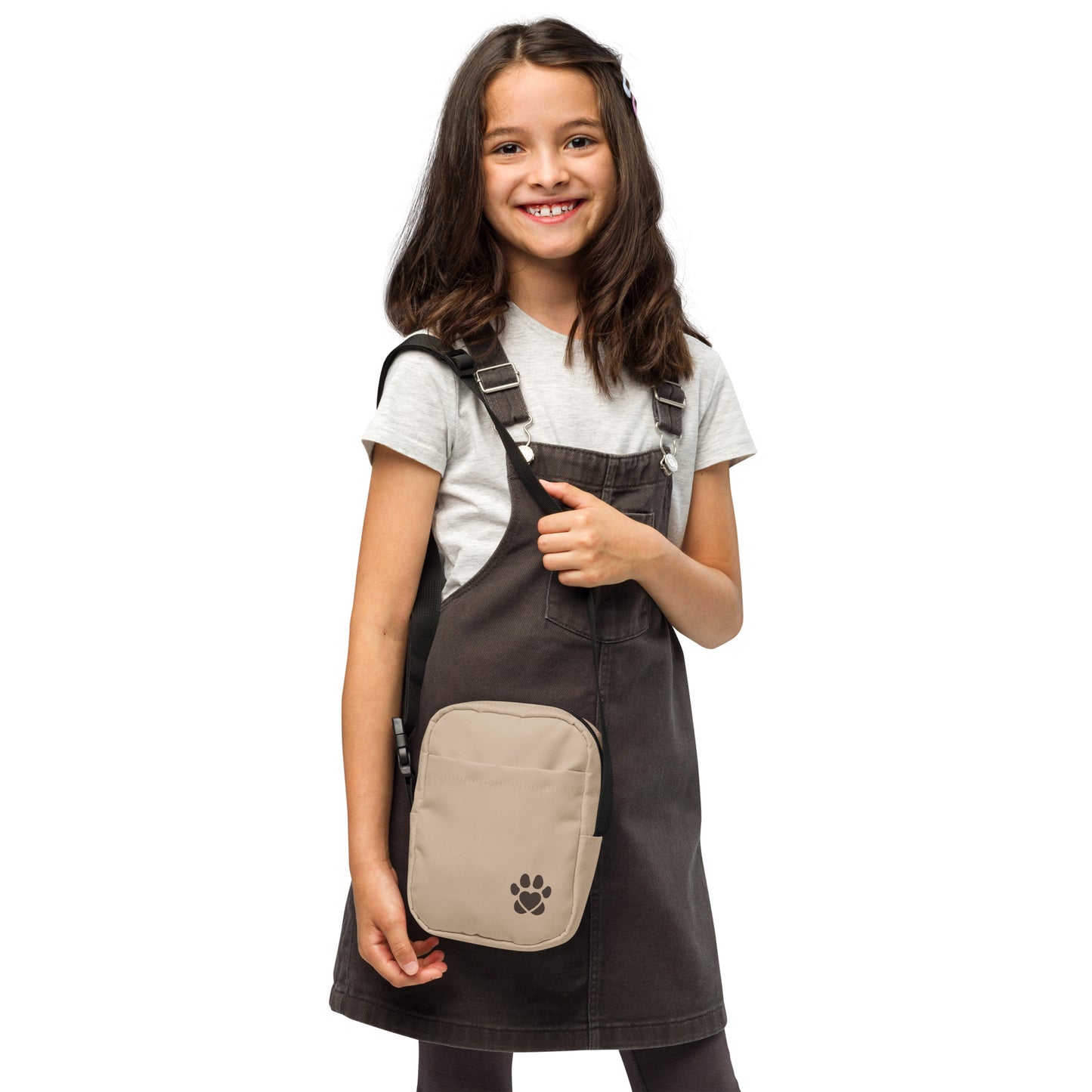 Young girl wearing a brown apron with a beige pocket featuring a paw print design on a white background.