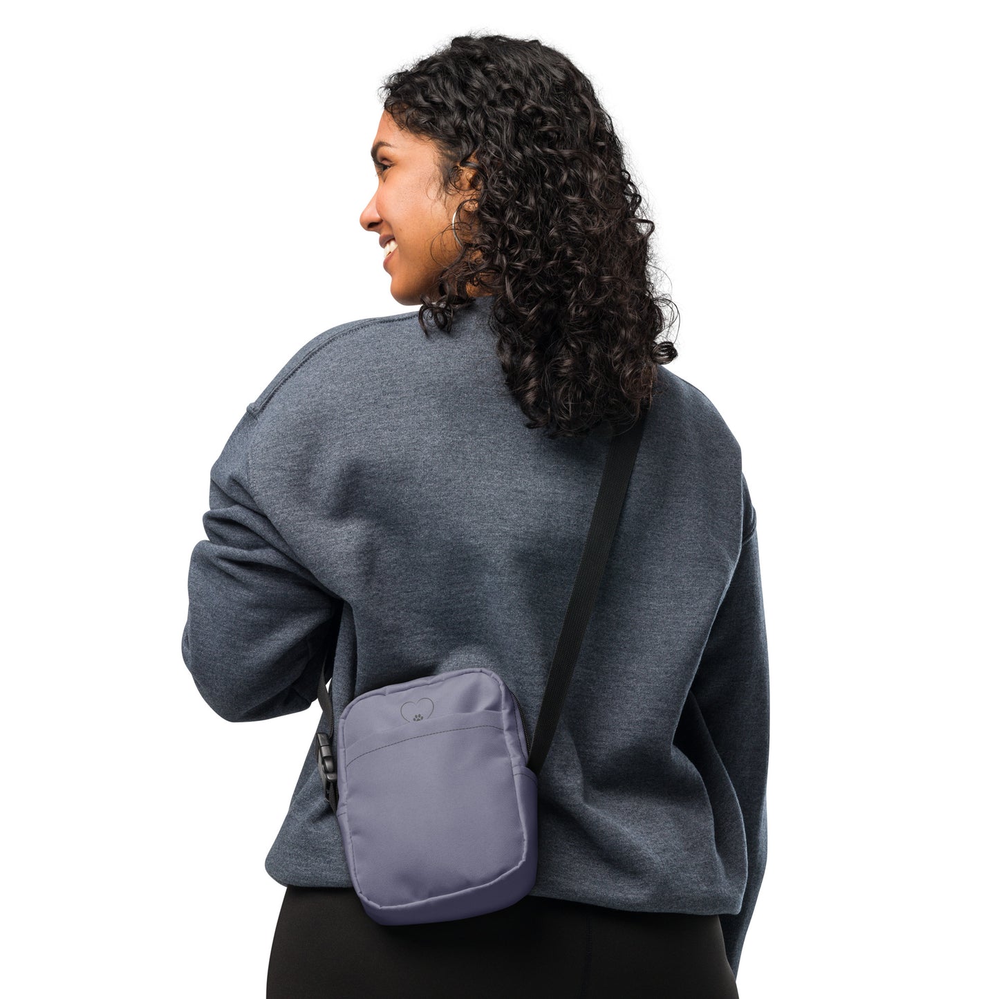 Person wearing a gray sweatshirt with a purple crossbody bag on a white background