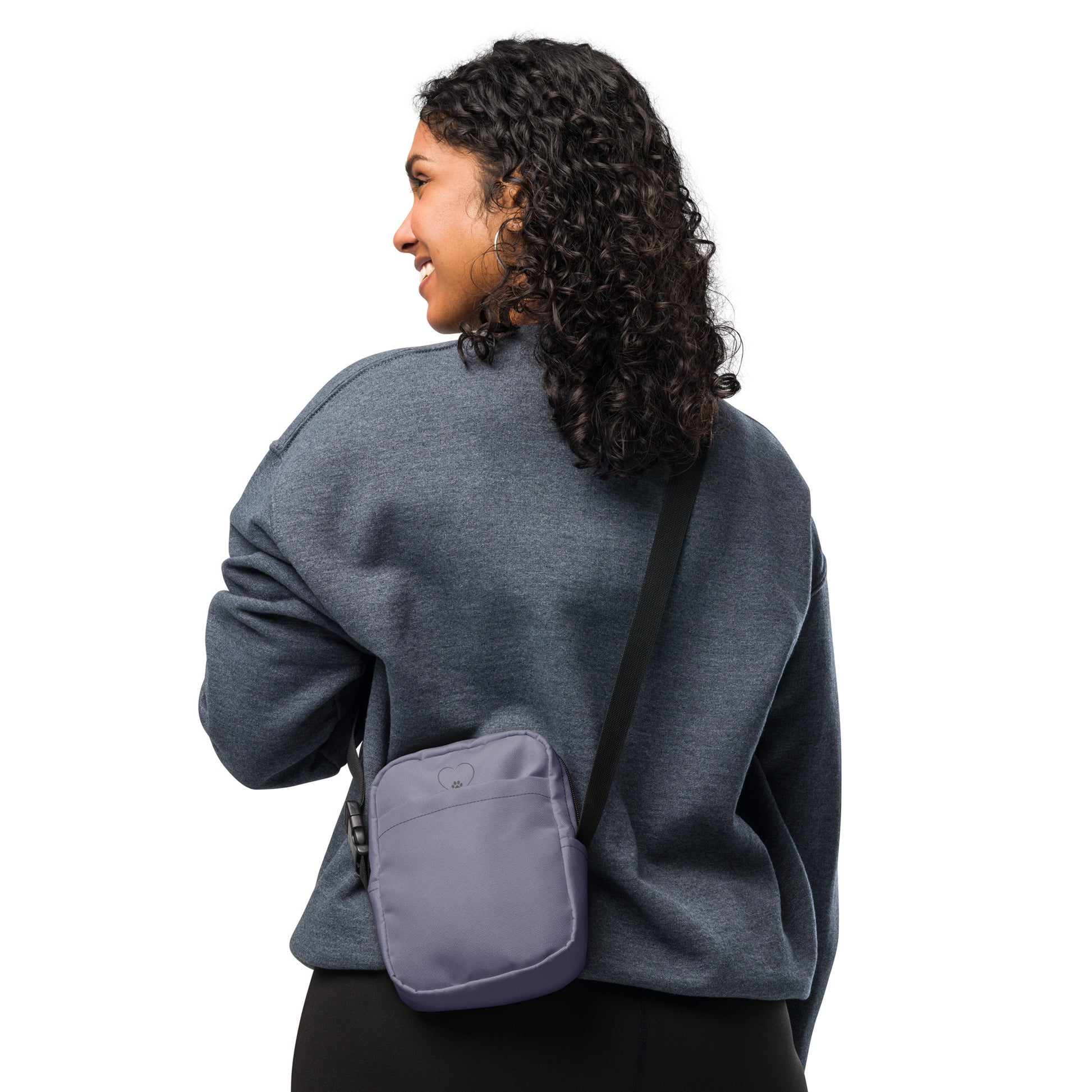 Person wearing a gray sweatshirt with a purple crossbody bag on a white background