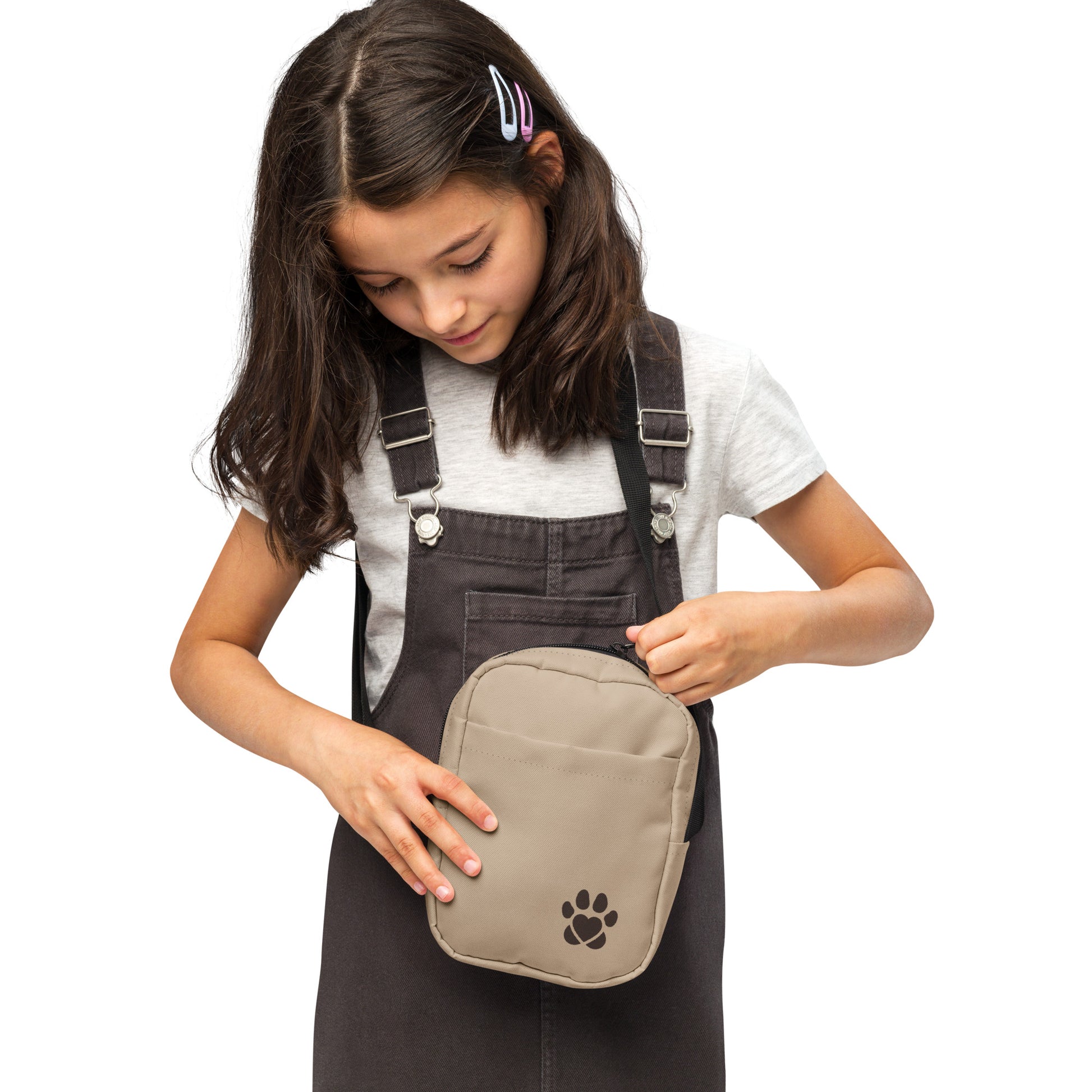 Girl holding a beige bag with a paw print on a white background