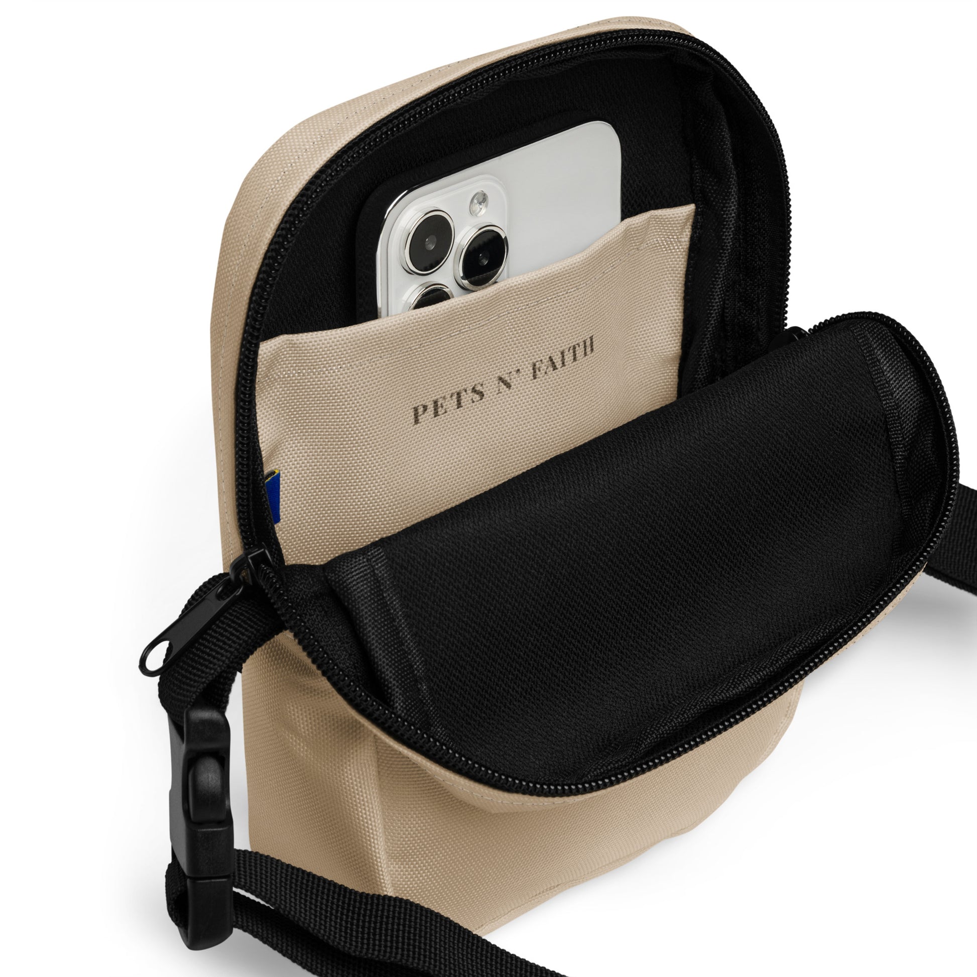 Beige crossbody bag with a phone inside on a white background