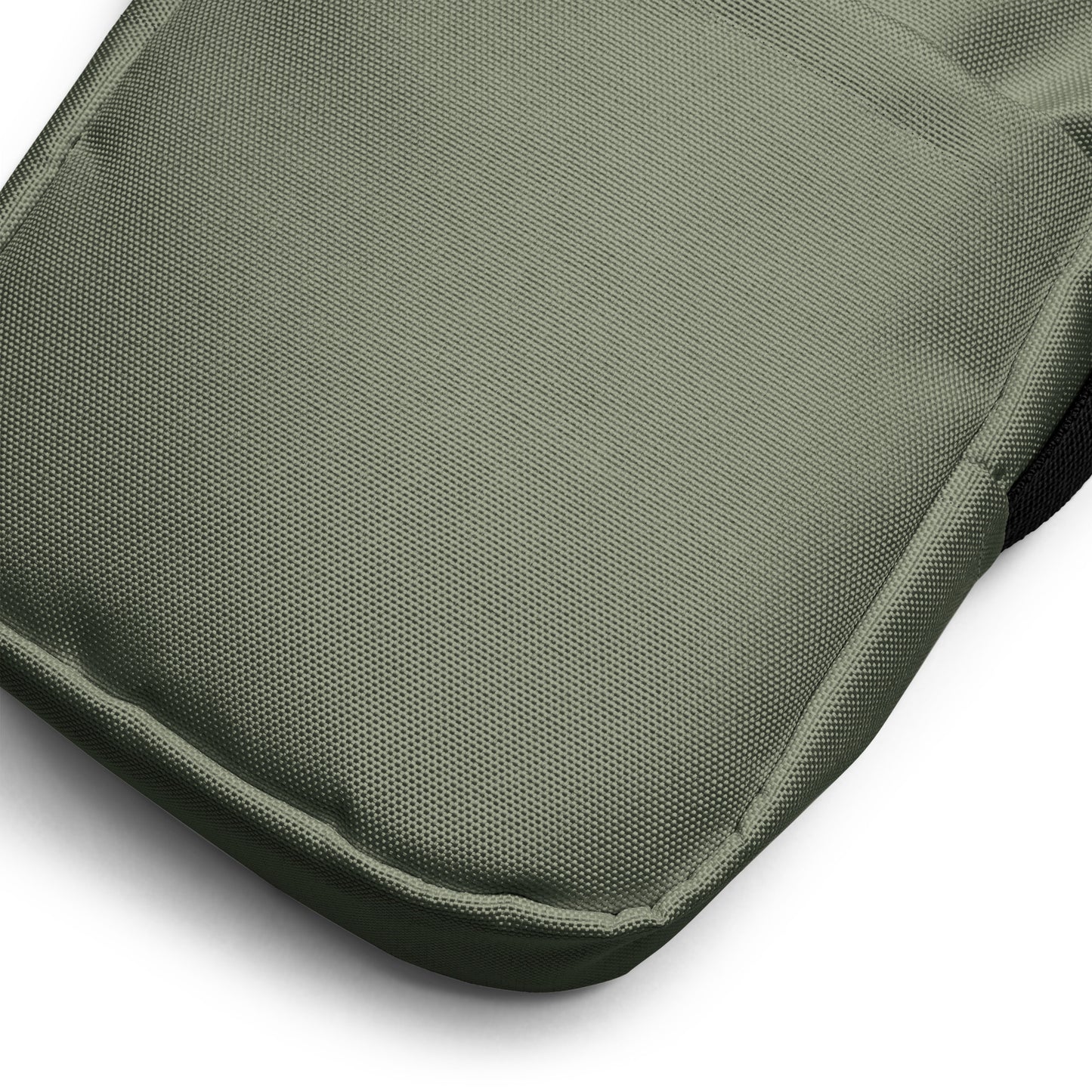 Close-up of a military green fabric surface with a textured pattern on a white background