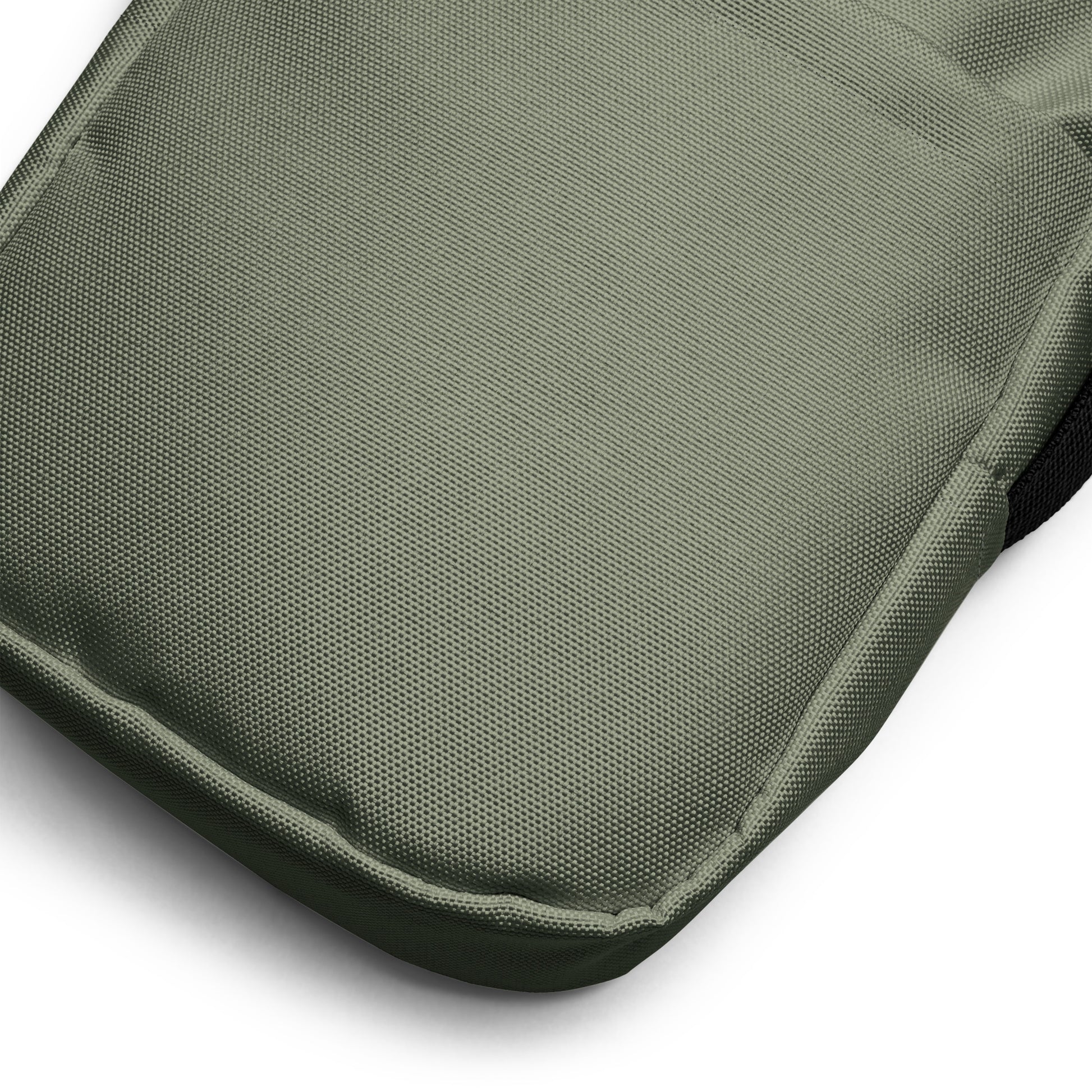 Close-up of a military green fabric surface with a textured pattern on a white background