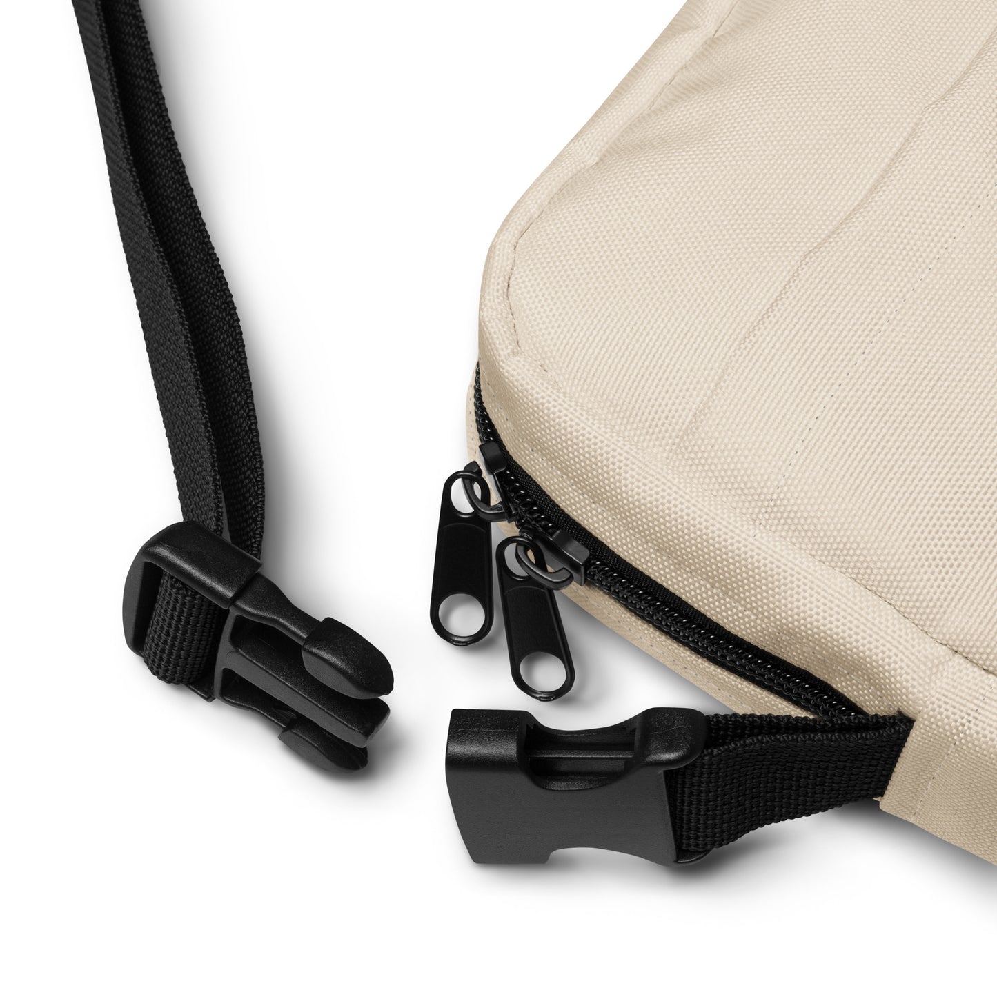Close-up of a beige bag with black zipper and strap on a white background