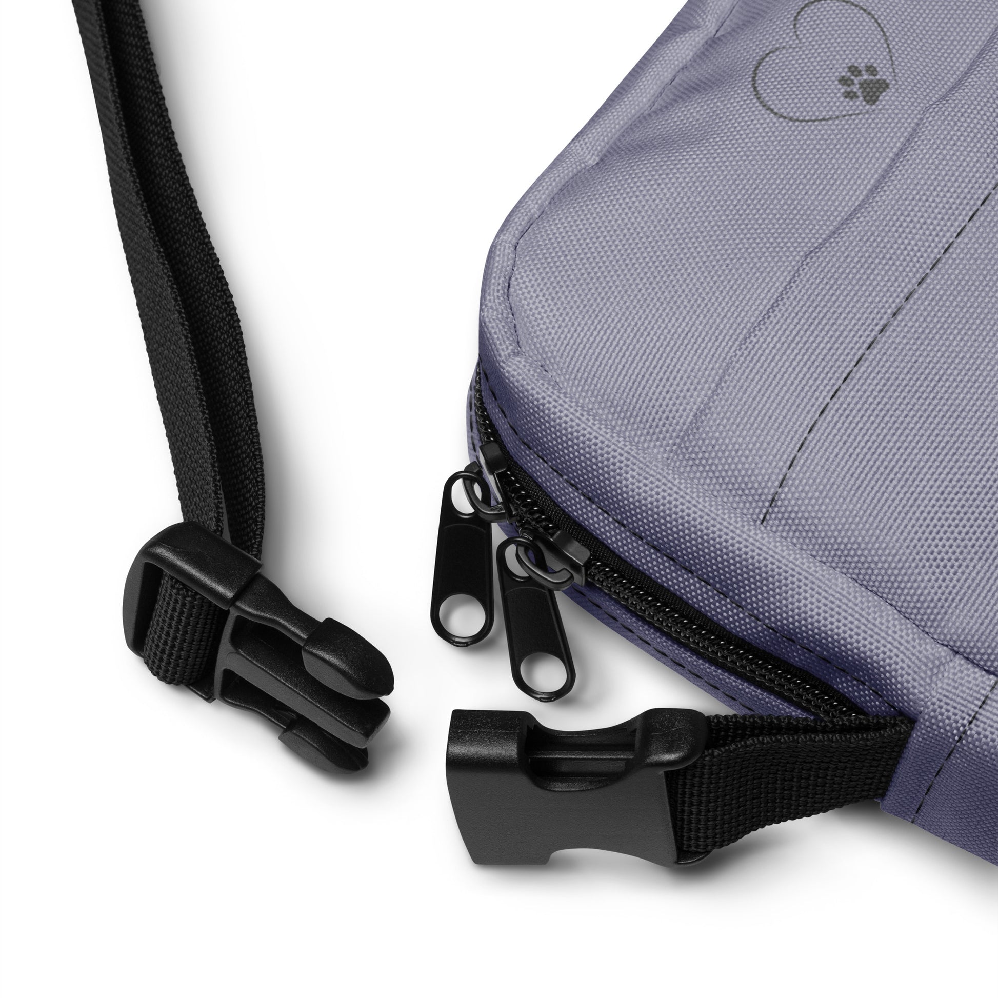 Close-up of a gray bag with black zippers and straps on a white background