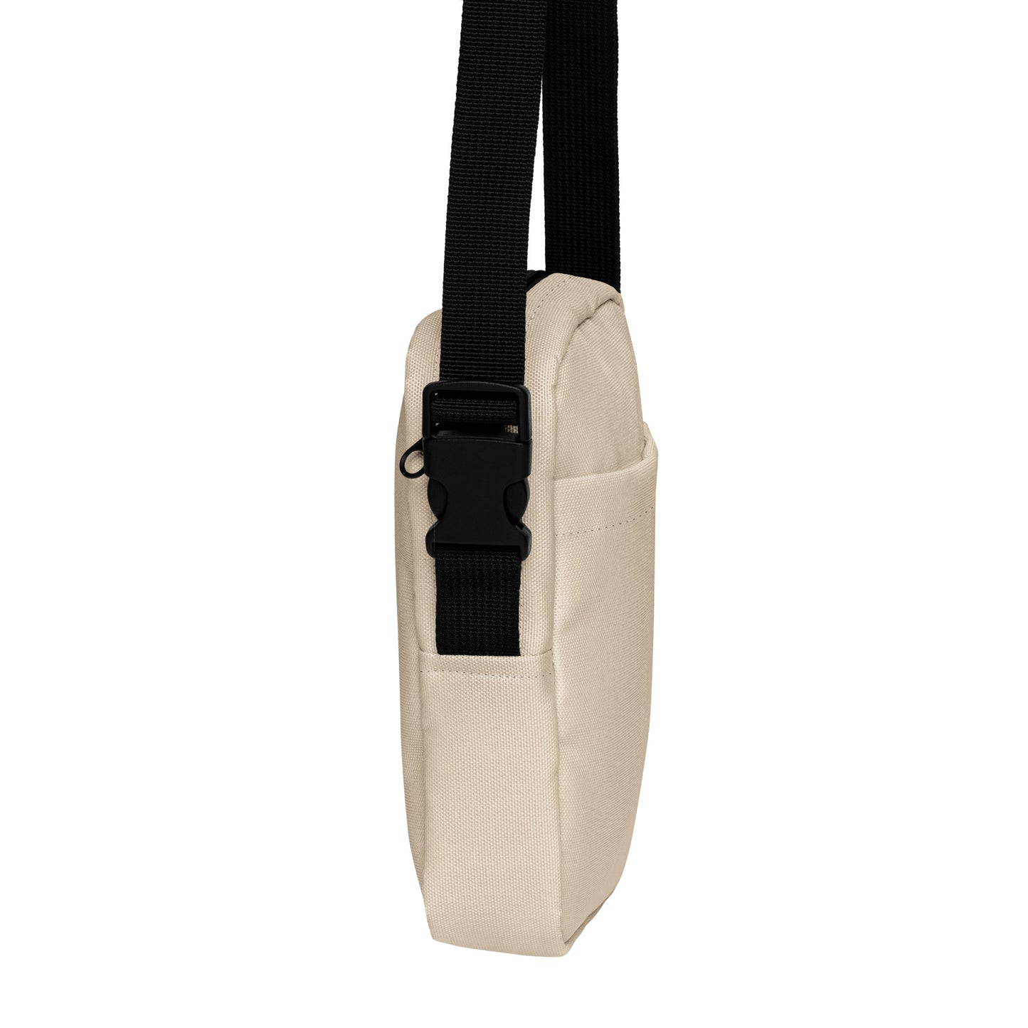 Beige crossbody bag with a black strap on a white background