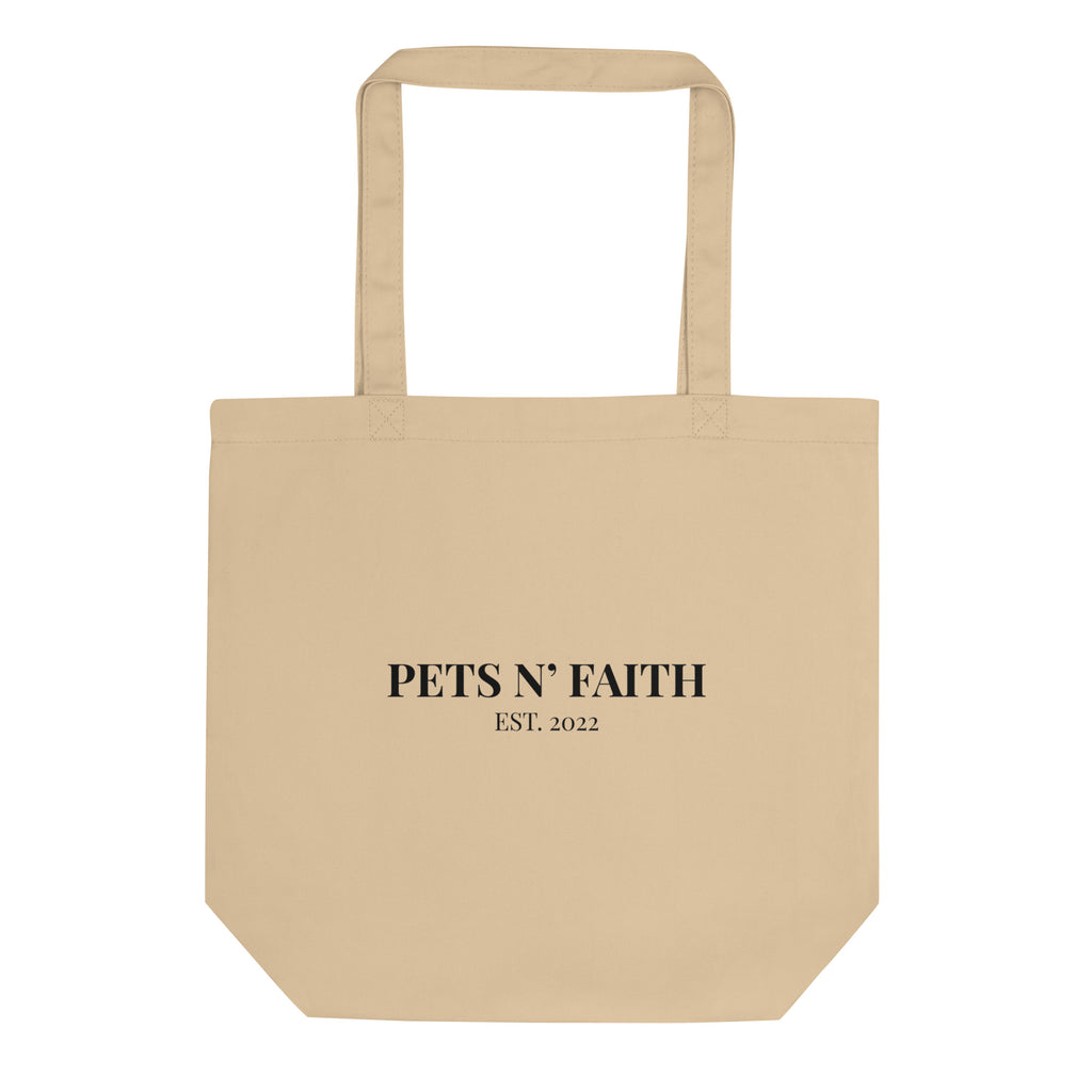 Beige organic cotton tote bag with black text “Pets N’ Faith Est. 2022” on front.
