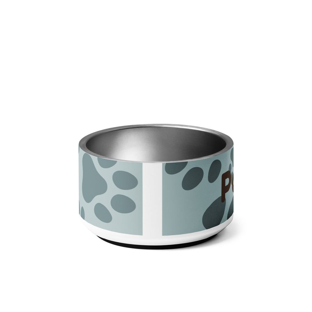 Back view of stainless steel pet bowl with soft blue background and scattered dark paw prints, featuring the text “Pawprints Pray” in brown bold and handwritten font.