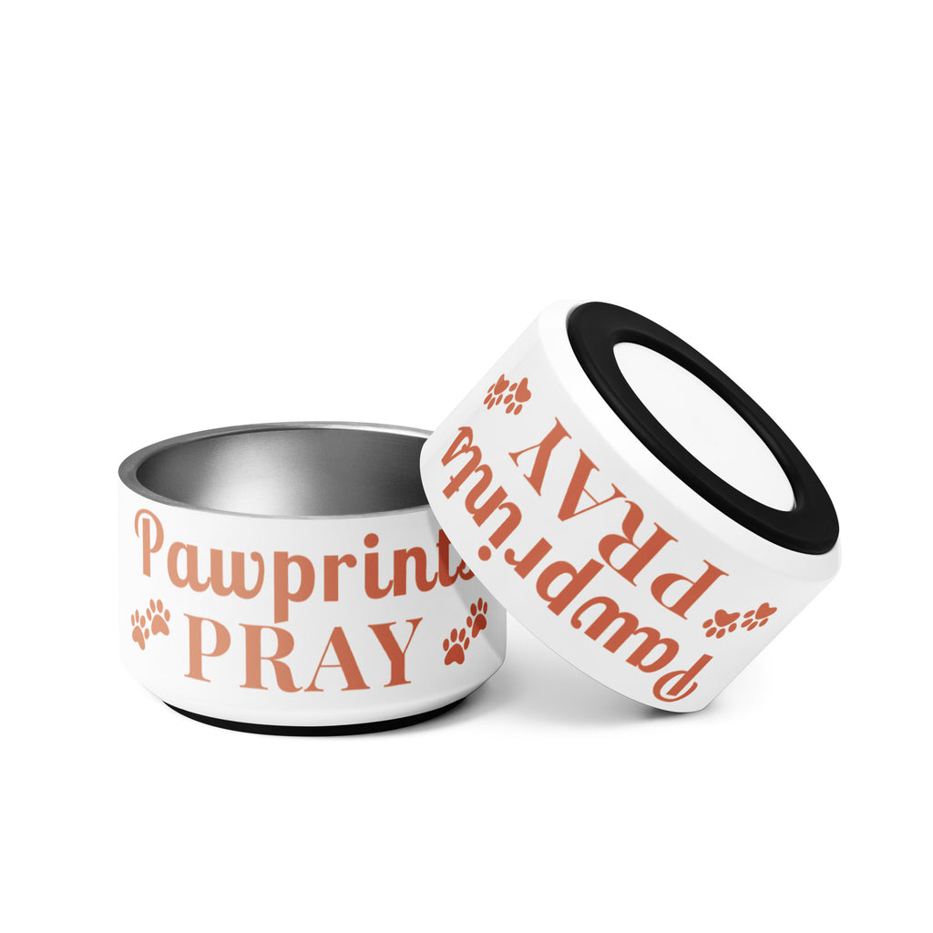 Two Pawprints Pray terracotta print stainless steel pet bowls, one upright and one tilted to show anti-slip rubber base.