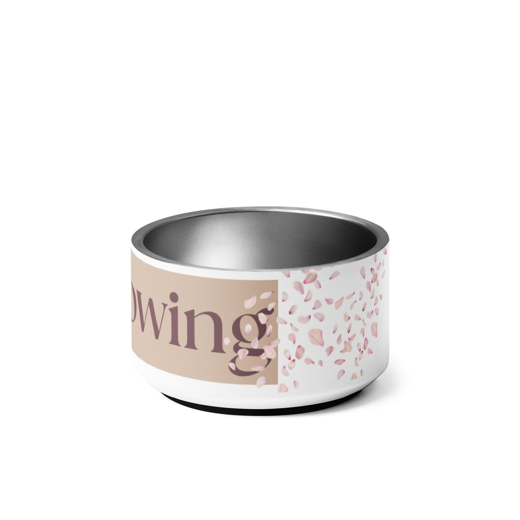 Close-up of the side view of the white stainless steel pet bowl with the words, “Overflowing” in the front and a rose petal design adorned on the sides.