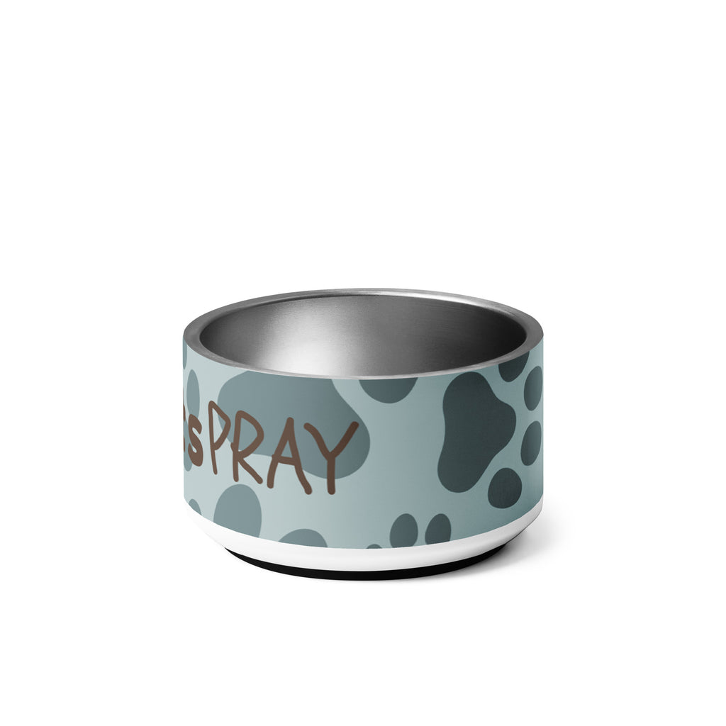 Stainless steel pet bowl with soft blue background and scattered dark paw prints, featuring the text “Pawprints Pray” in brown bold and handwritten font.