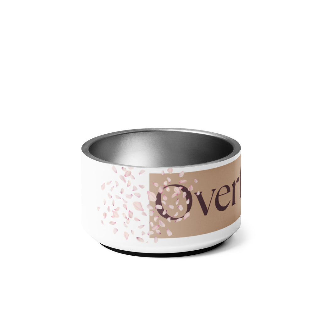 Close-up of the side view of the white stainless steel pet bowl with the words, “Overflowing” in the front and a rose petal design adorned on the sides.
