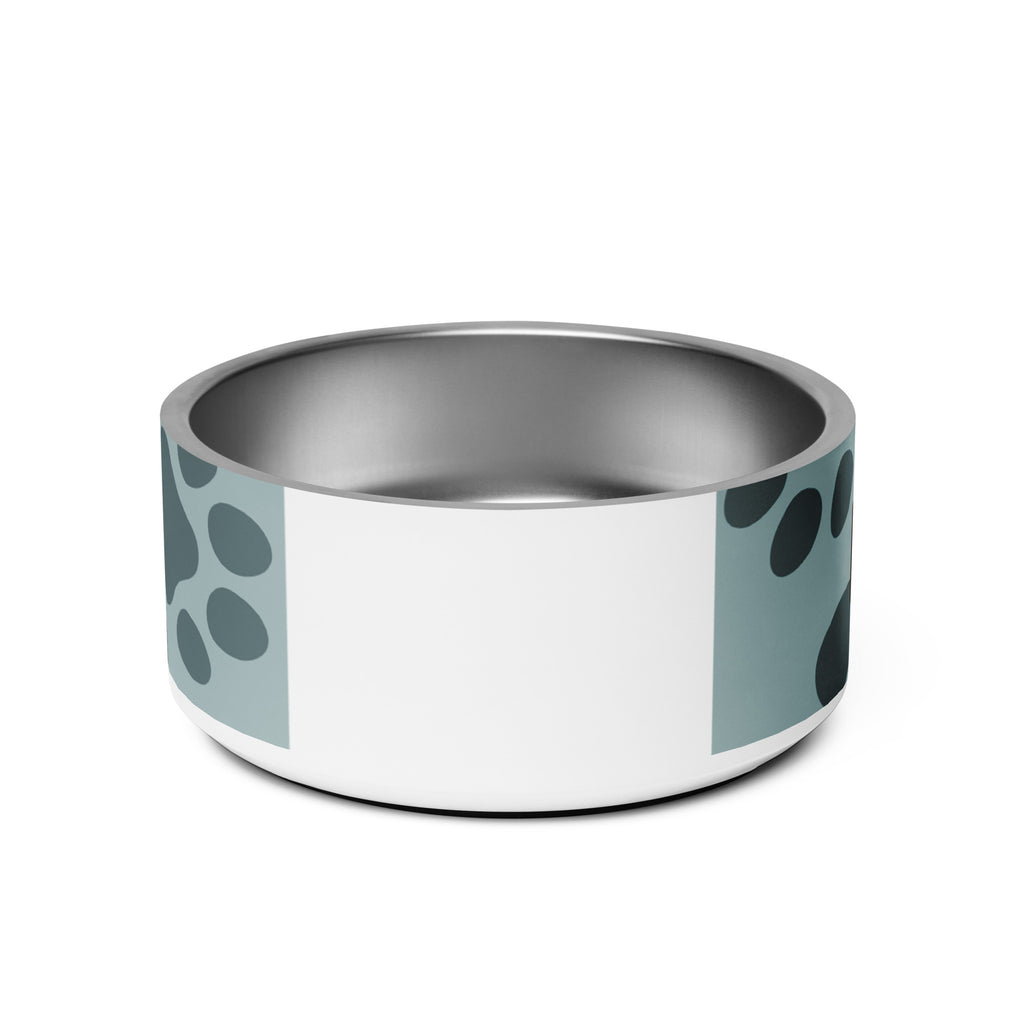 Back view of stainless steel pet bowl with soft blue background and scattered dark paw prints, featuring the text “Pawprints Pray” in brown bold and handwritten font.