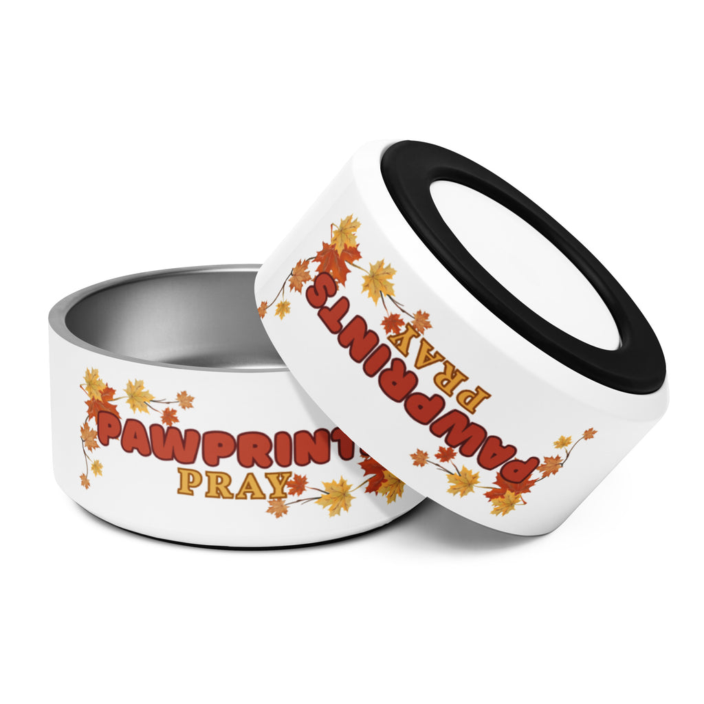 Stainless steel pet bowl with "Pawprints Pray" text and autumn leaf design, empty.