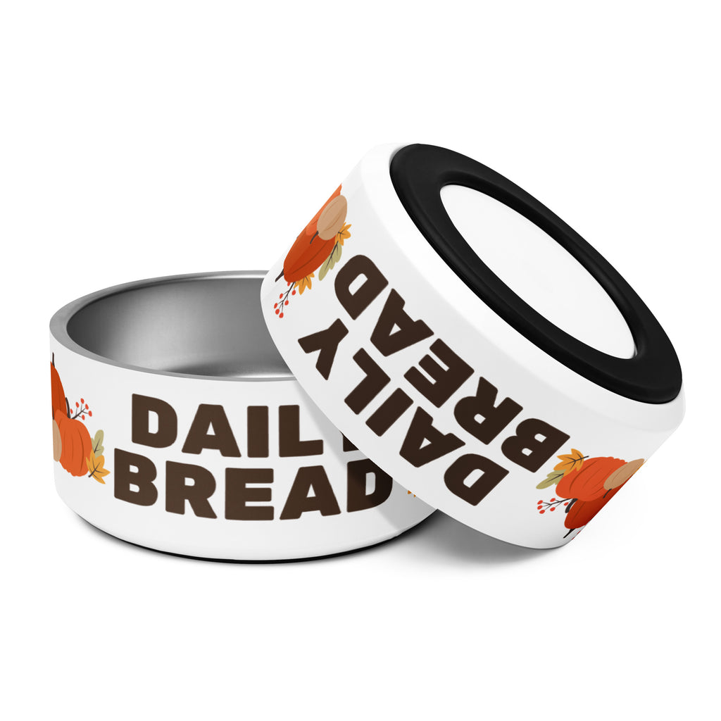 Two Daily Bread stainless steel pet bowls, one upright and one tilted to show non-slip rubber base.