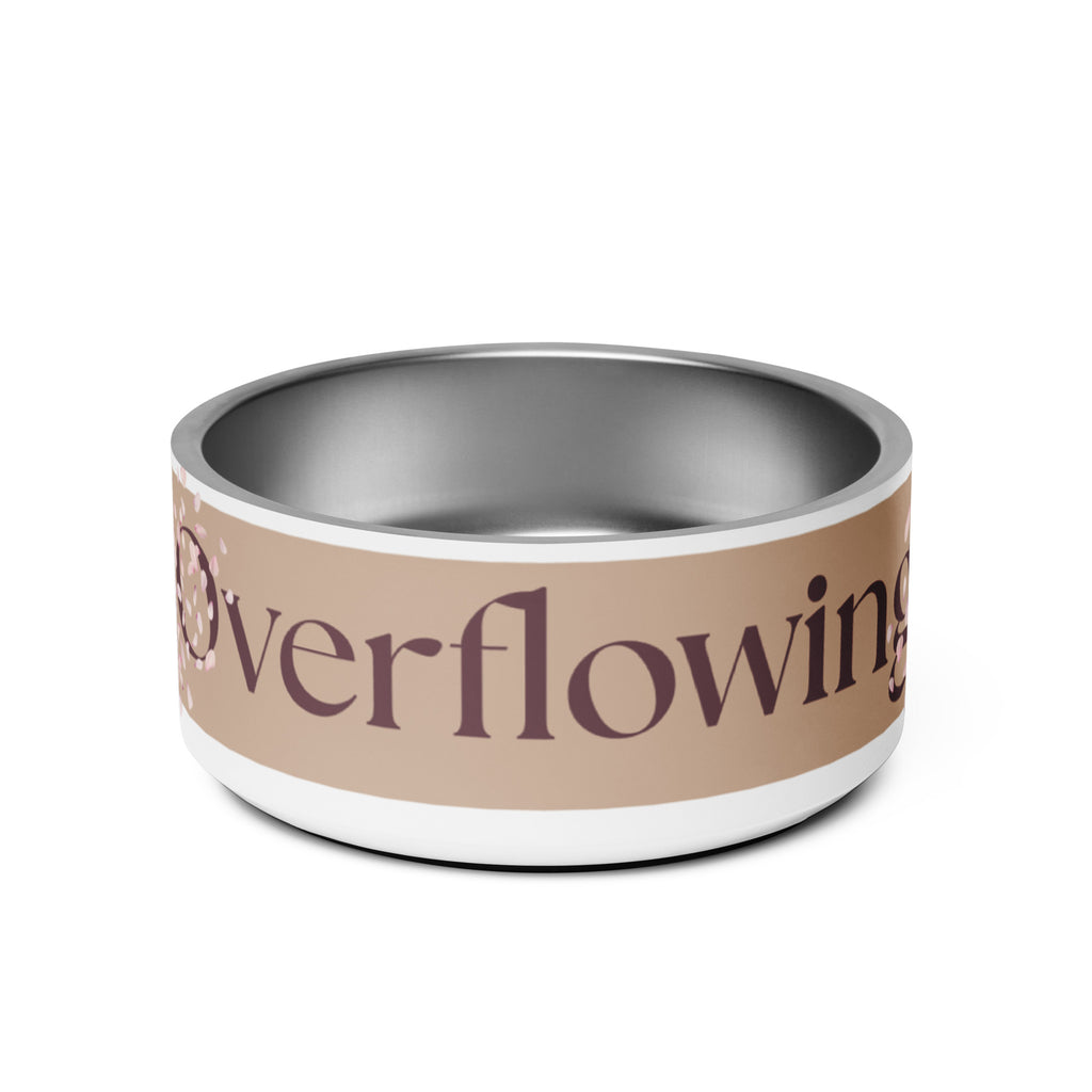 Close-up of the white stainless steel pet bowl with the words, “Overflowing” in the front and a rose petal design adorned on the sides.