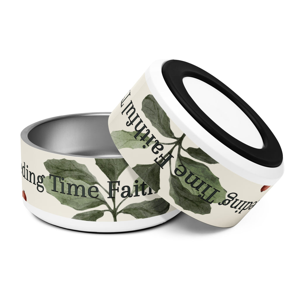 Stainless steel pet bowl with cream exterior and green leaf botanical pattern, text “Feeding Time, Faithful Time” around the rim, anti‑slip base visible