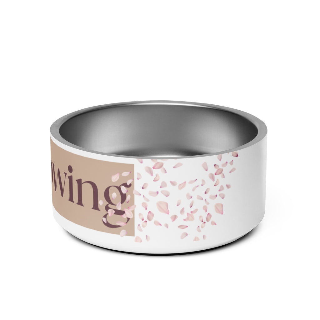 Close-up of the side view white stainless steel pet bowl with the words, “Overflowing” in the front and a rose petal design adorned on the sides.