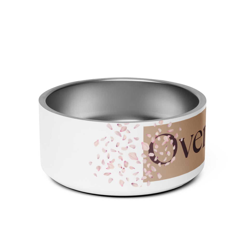 Close-up of the side view of the white stainless steel pet bowl with the words, “Overflowing” in the front and a rose petal design adorned on the sides.