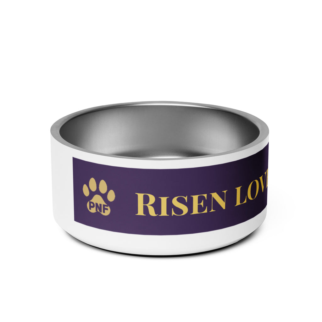 Side view of stainless steel pet bowl with a deep purple exterior and golden text reading “Risen Love, Renewed Paw,” finished with a white base, two gold paws on the side, and non-slip bottom.