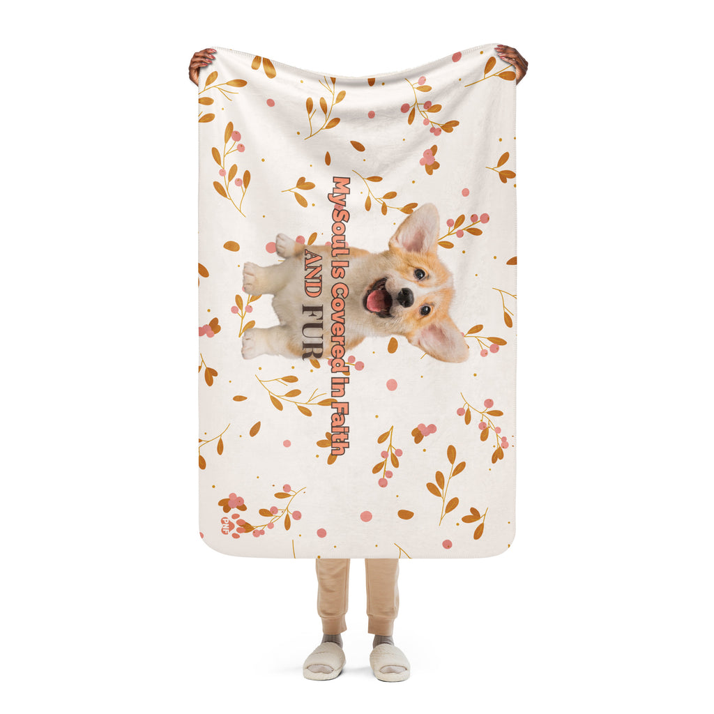 Person holding floral sherpa blanket with a corgi with the words, " My Soul Is Covered in Faith and FUR". 