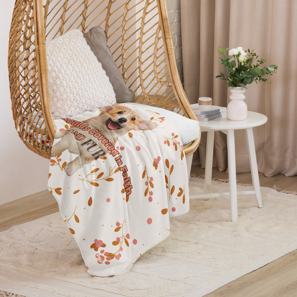 Draped sherpa blanket inside of chair. Floral sherpa blanket with a corgi with the words, " My Soul Is Covered in Faith and FUR". 