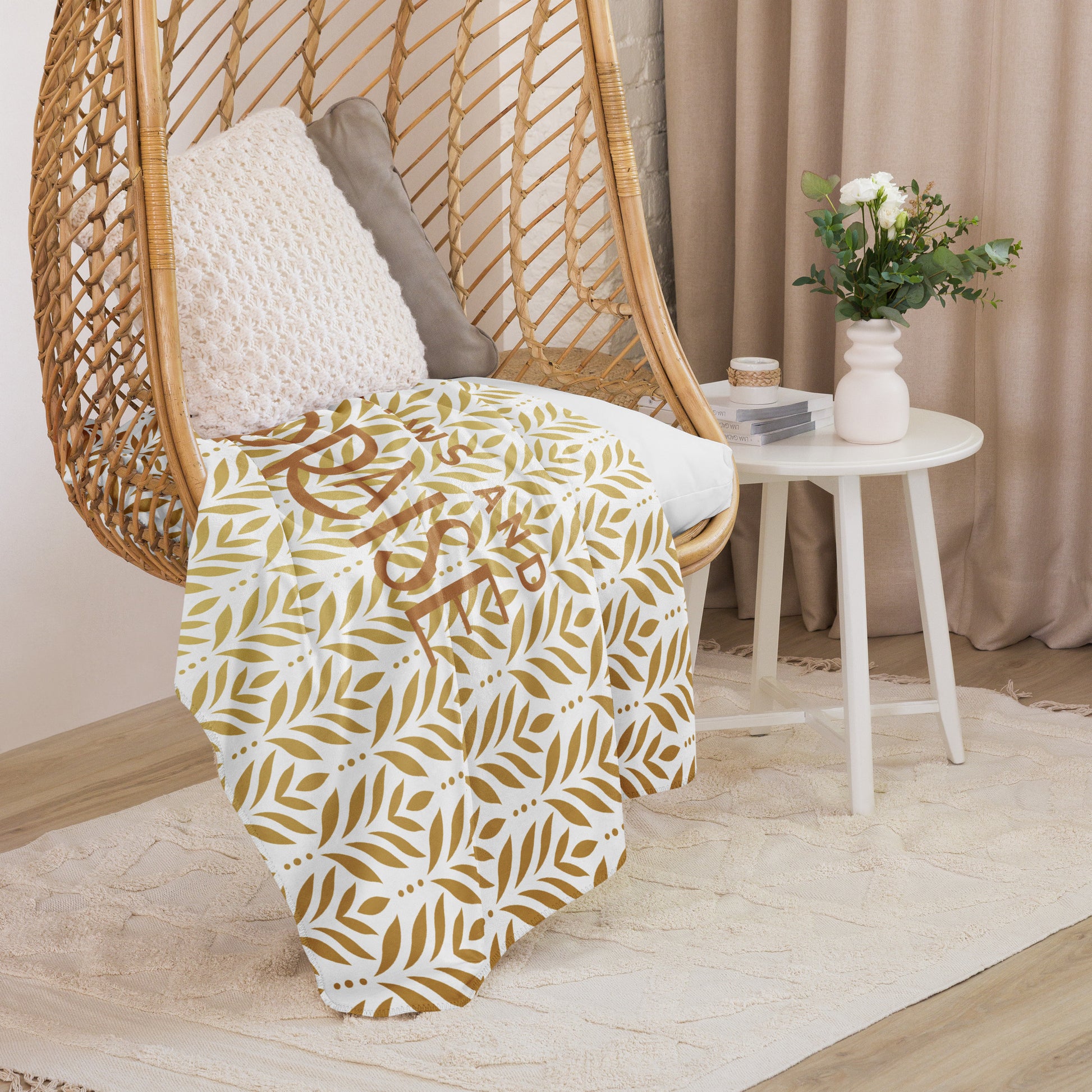 Sherpa blanket featuring a gold leaf pattern and “Paws and Praise” lettering in warm tones, a faith-inspired design that symbolizes gratitude, comfort, and the love between pets and their owners.