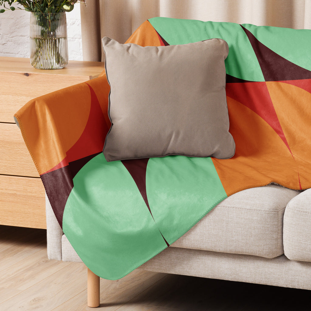 Sherpa blanket with orange, teal, and red geometric mid-century design featuring a black paw print in the corner, Pets N’ Faith faith-inspired throw