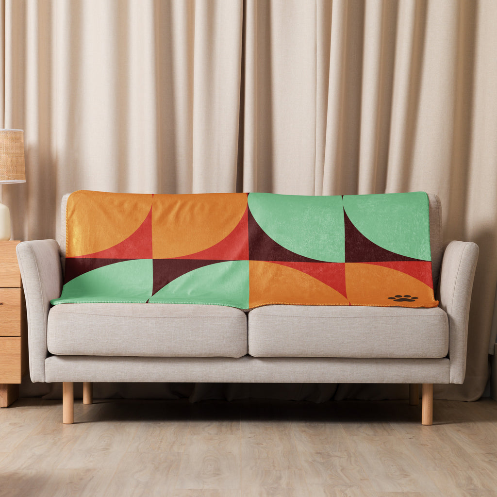 Sherpa blanket with orange, teal, and red geometric mid-century design featuring a black paw print in the corner, Pets N’ Faith faith-inspired throw