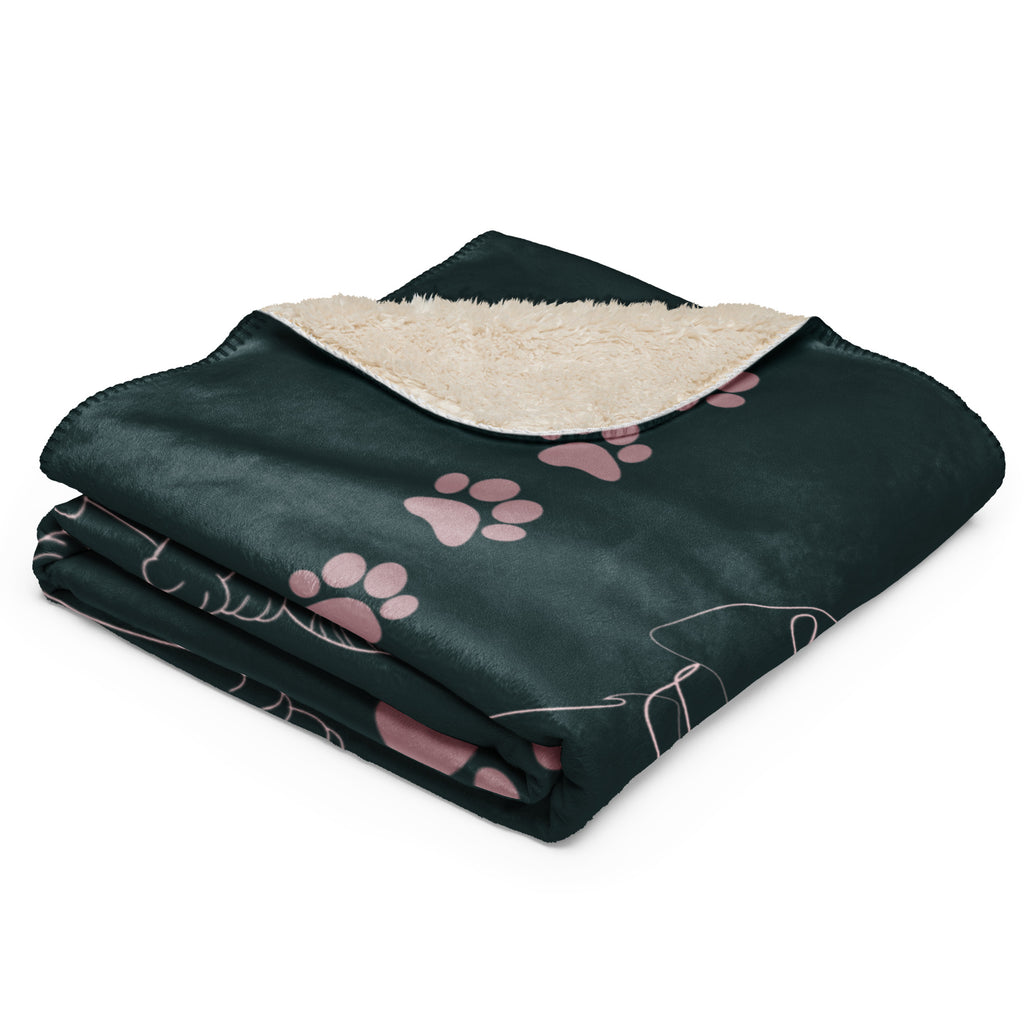 Folded view of forest green sherpa blanket with pink drawings of cats and dogs with the phrase, " God's Little Helpers". 