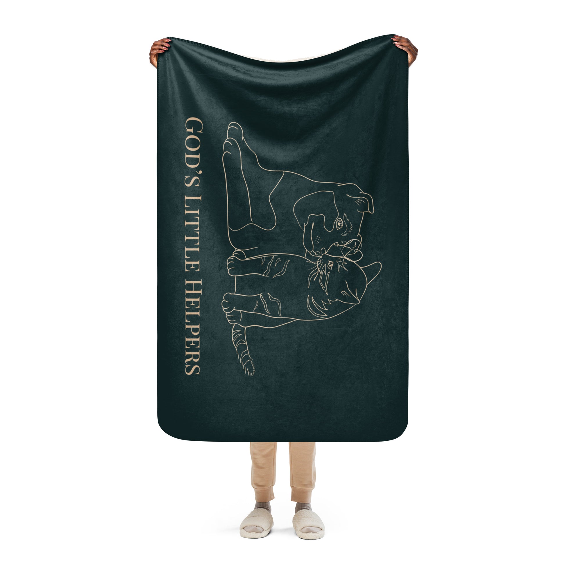 Person holding a dark green blanket with a white outline of a dog and text on a white background