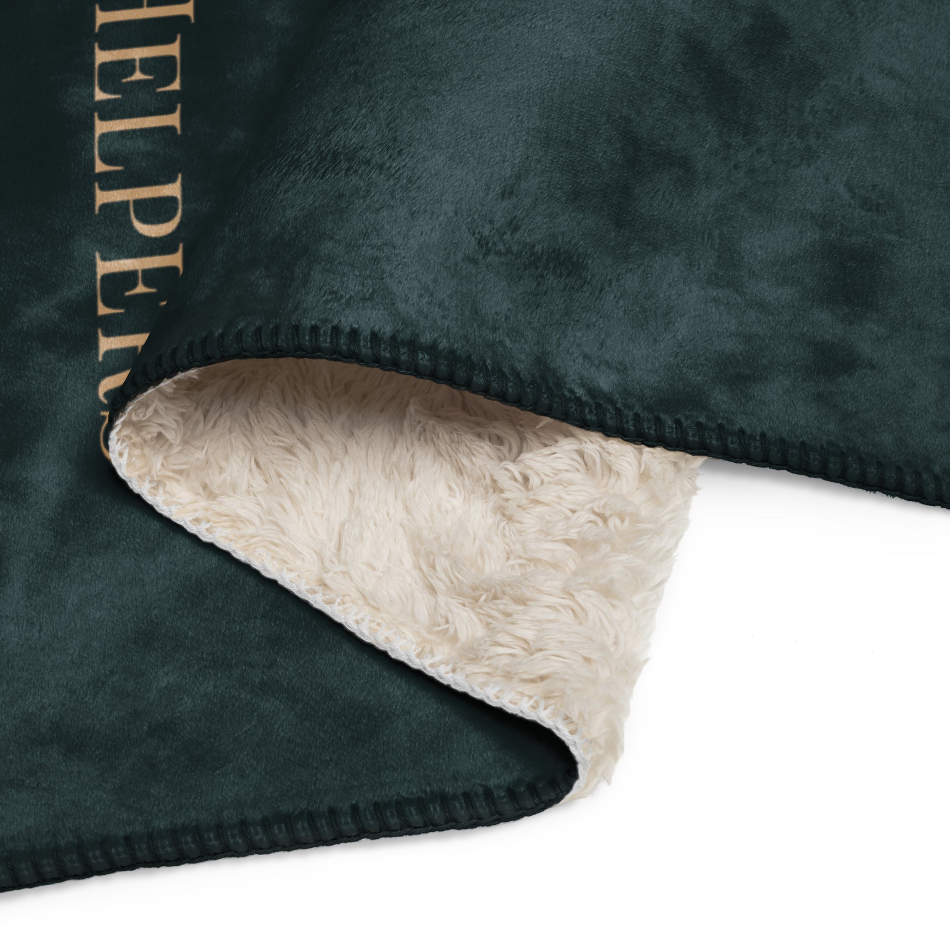 Dark green fleece blanket with beige sherpa lining on a white background