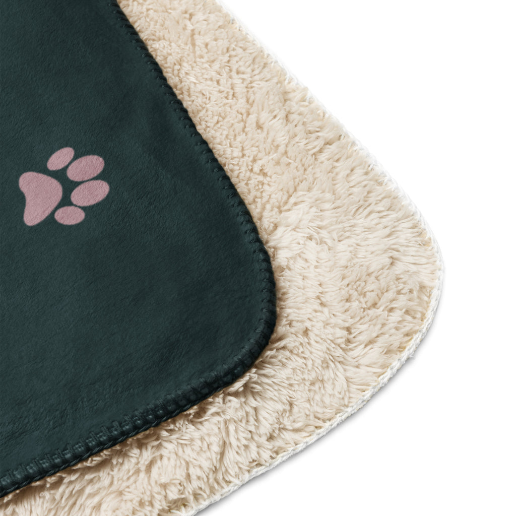 Front view of forest green sherpa blanket with pink drawings of cats and dogs with the phrase, " God's Little Helpers". 