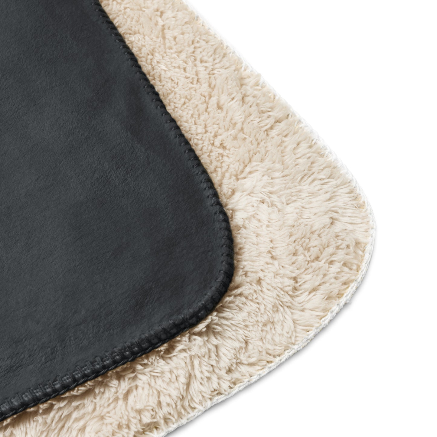 Close-up of a black and beige rug corner on a white background