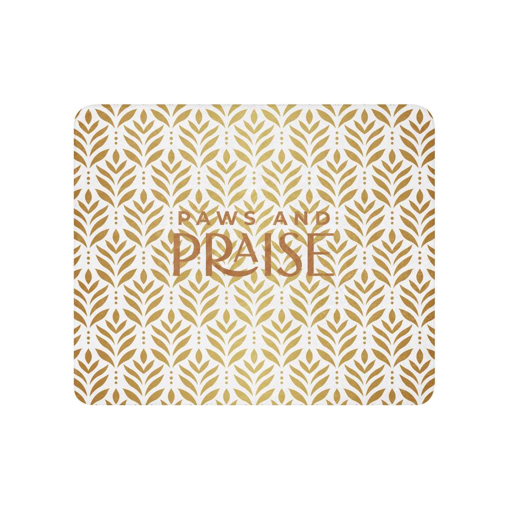 Sherpa blanket featuring a gold leaf pattern and “Paws and Praise” lettering in warm tones, a faith-inspired design that symbolizes gratitude, comfort, and the love between pets and their owners.