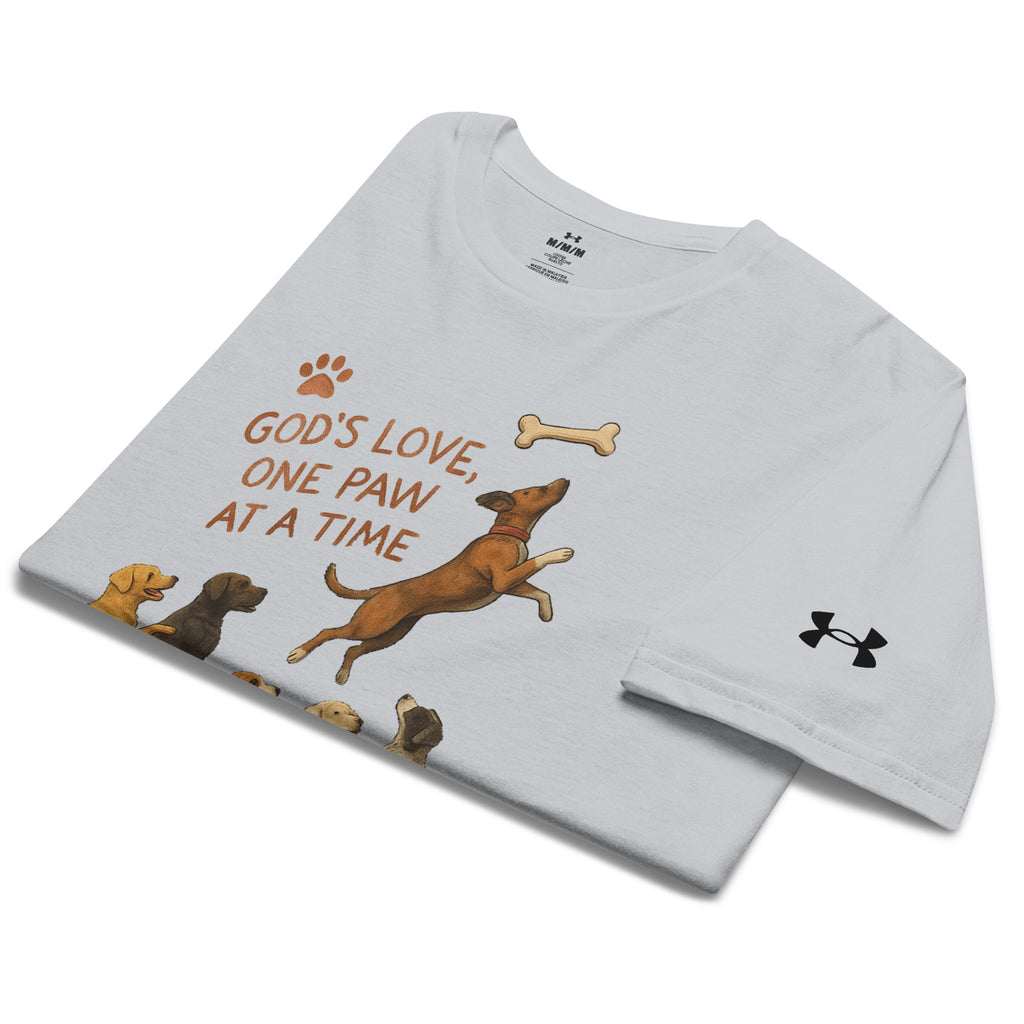 Folded light gray Under Armour Pets N’ Faith Performance T-Shirt with “ God's Love, One Paw at A Time” design and Under Armour sleeve logo